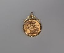 An Elizabeth II gold sovereign dated 1980, in a 9ct gold slip mount, approximately 8.