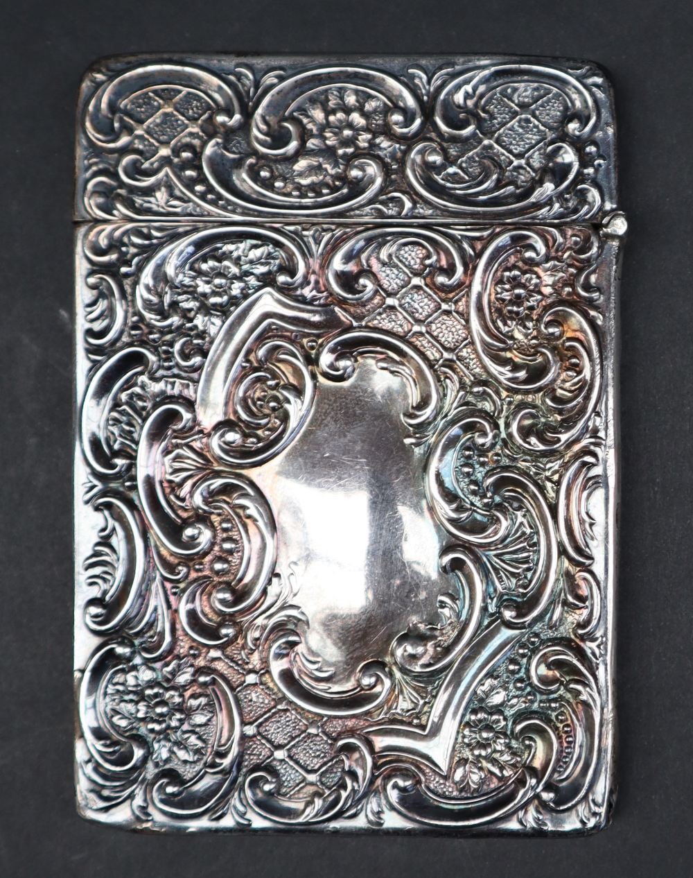 An Edwardian silver card carrying case with embossed decoration of a stag and scrolling leaves, - Image 3 of 4