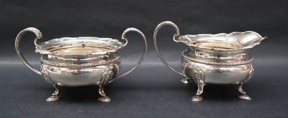 A George V silver cream jug and matching twin handled sugar basin, with a shaped leaf cast edge, - Image 2 of 4