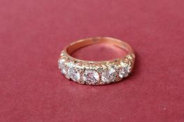 An 18ct gold five stone diamond ring, set with round old cut diamonds to an 18ct yellow gold shank,