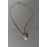 An 18ct white gold diamond set pendant of floral form set with seven round brilliant cut diamonds