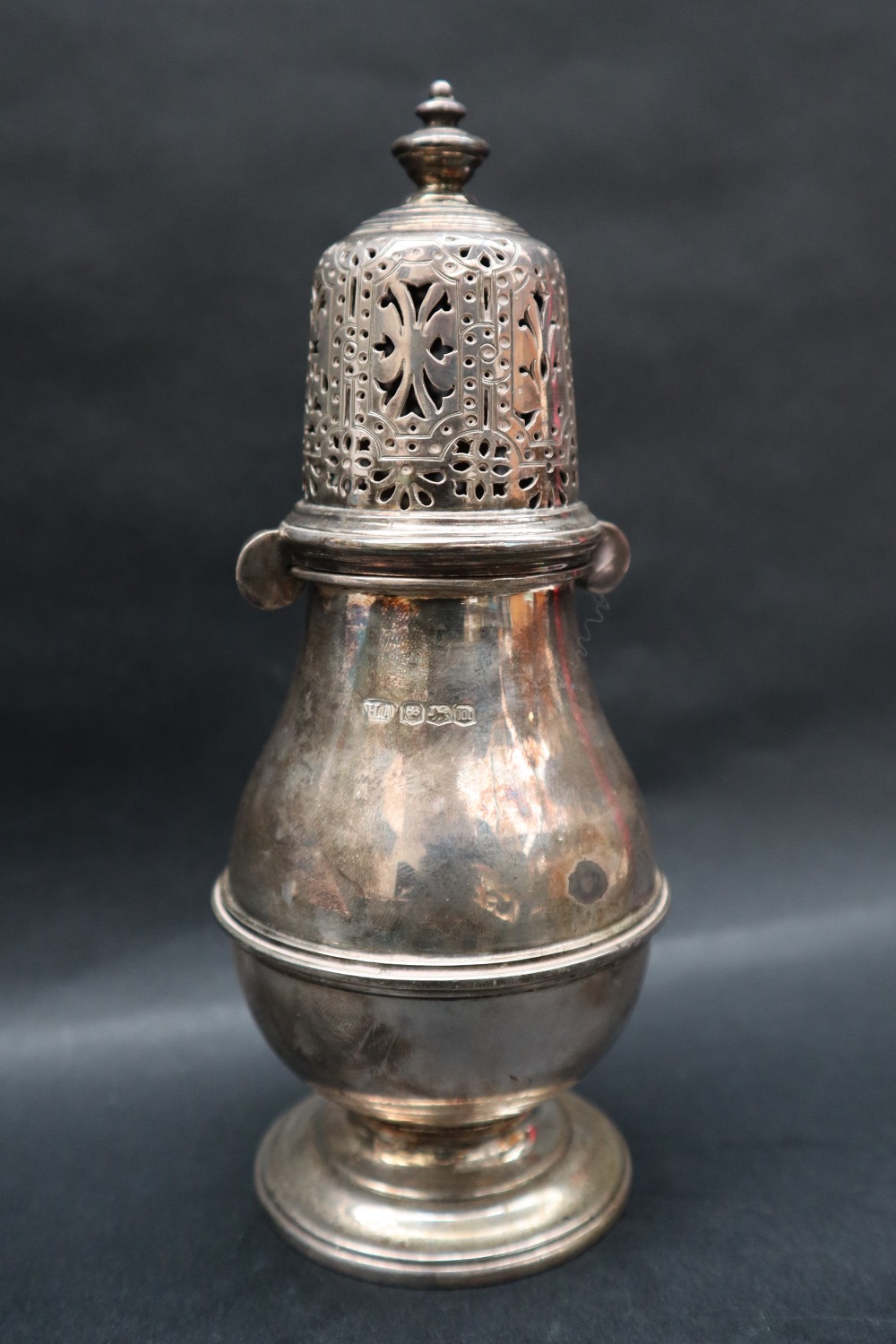 A George V silver sugar caster with a pierced domed cover and ring turned baluster body on a - Image 3 of 3