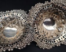A pair of late Victorian silver bon bon dishes with a leaf and cast border and pierced rim,