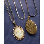 A 9ct yellow gold locket of oval form with a textured cover,