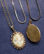 A 9ct yellow gold locket of oval form with a textured cover,