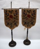 A pair of 19th century tapestry table top face screens with shield shaped woolwork panels decorated