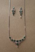 An Emerald and diamond necklace set with eight oval faceted emeralds and old round cut diamonds to