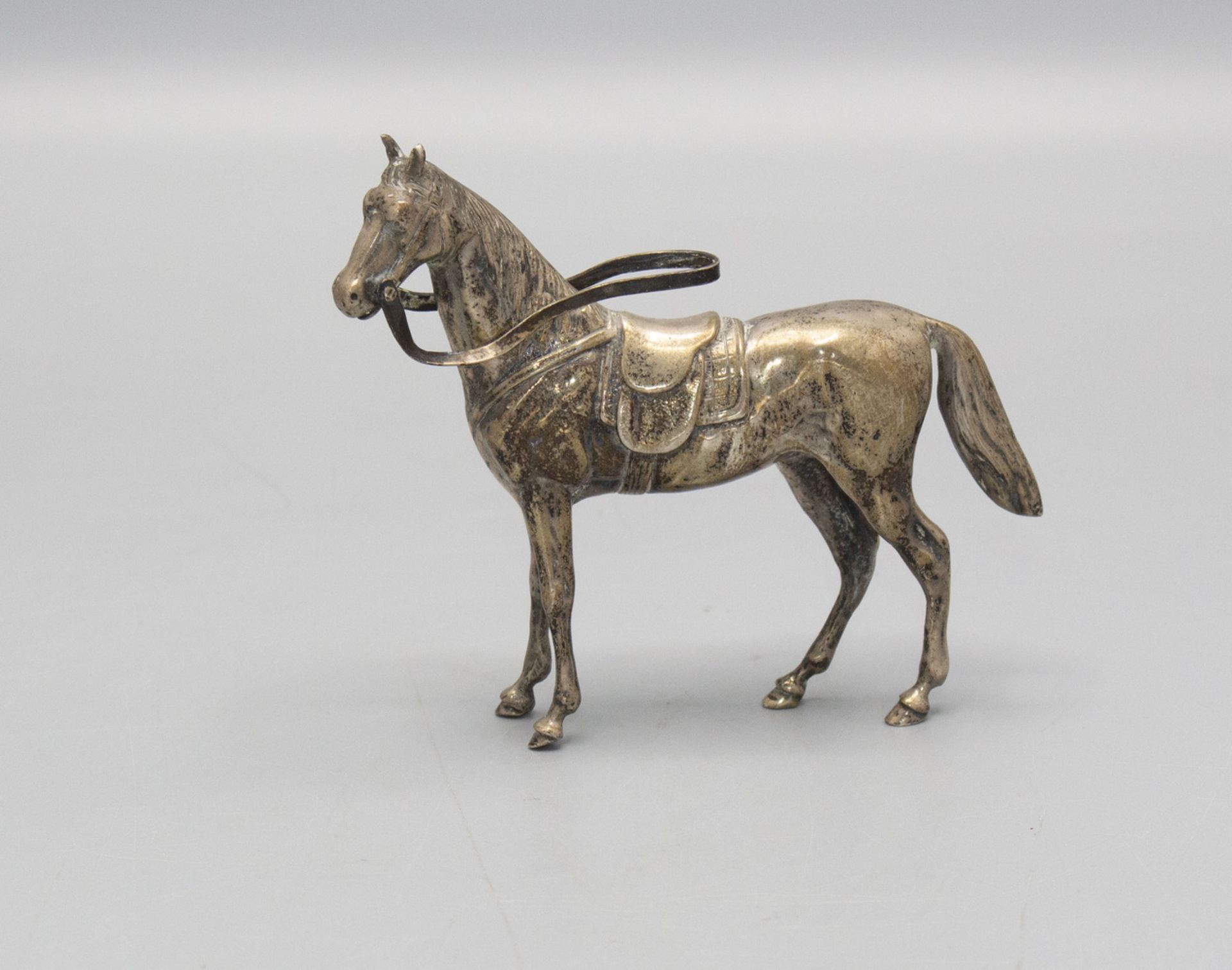Pferdefigur mit Sattel und Trense / A silver figure of a horse with saddle and bridle, J.D. ...