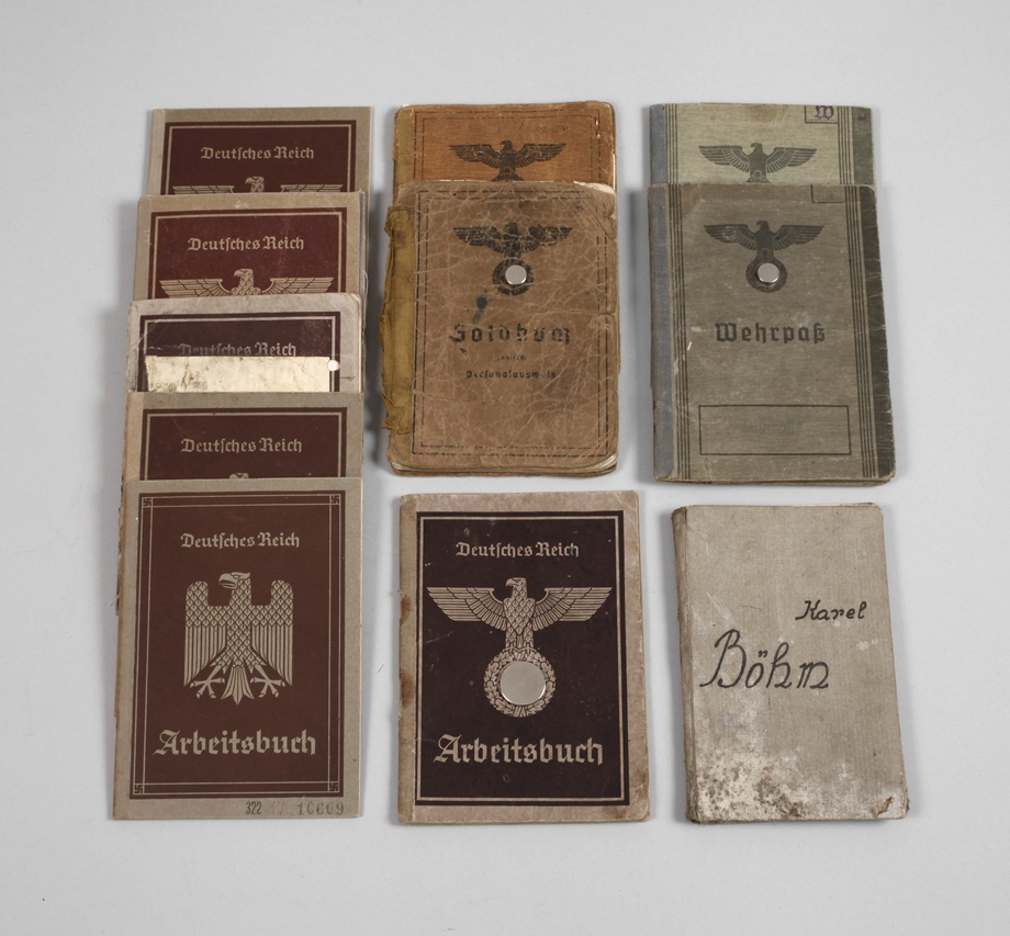 A collection of military passports, pay books, work books