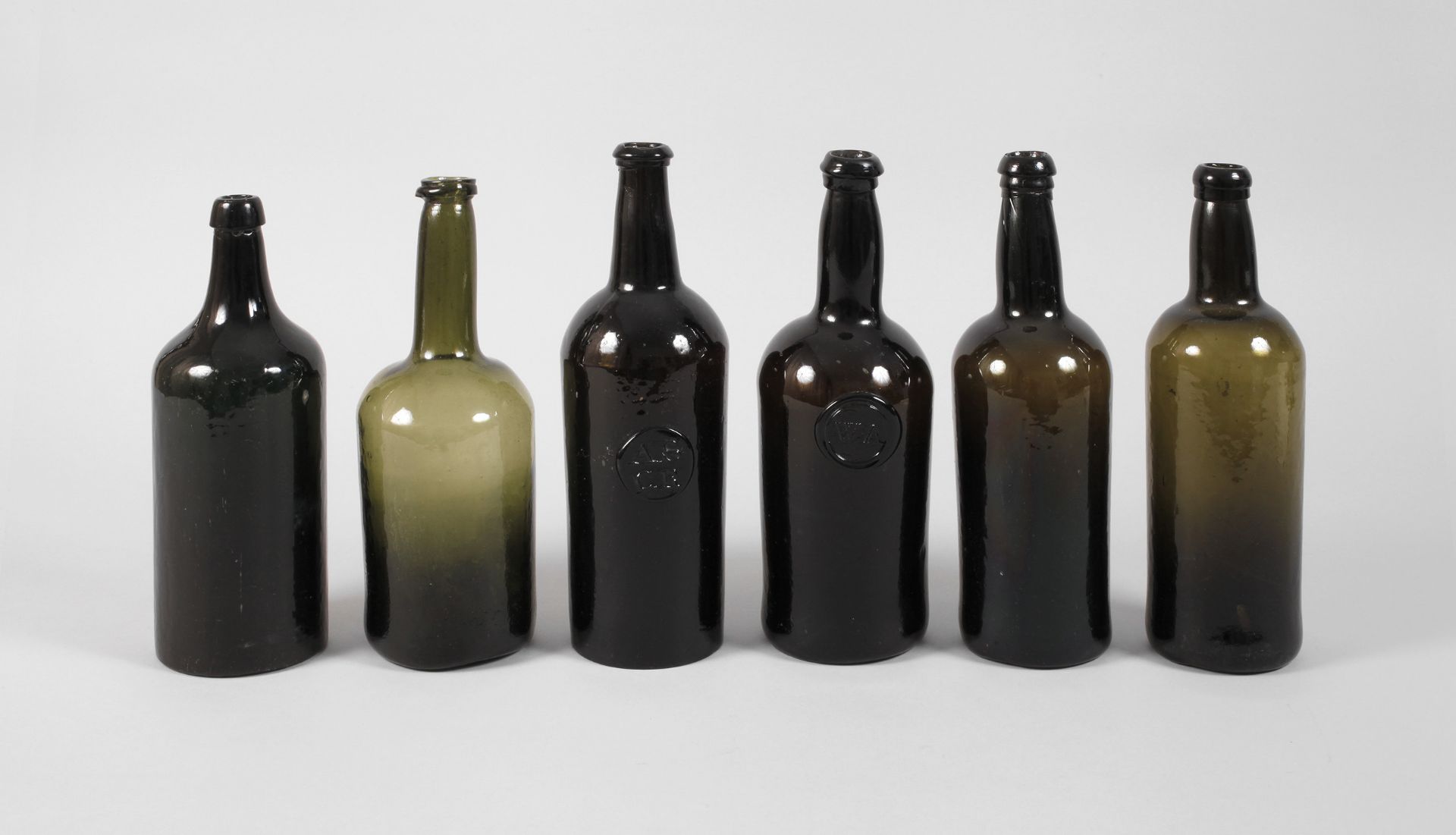 Six baroque wine bottles