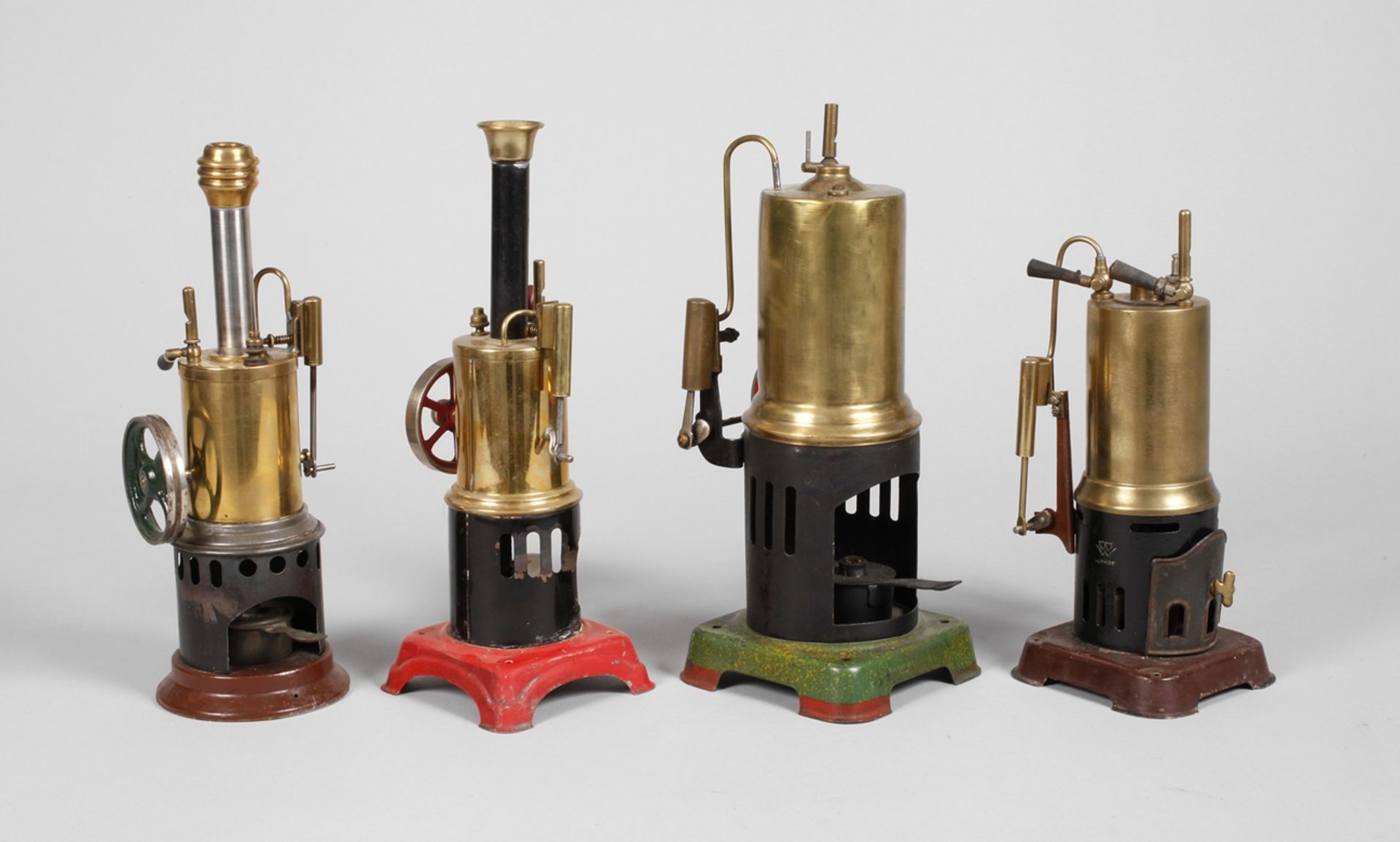 Four small standing steam engines