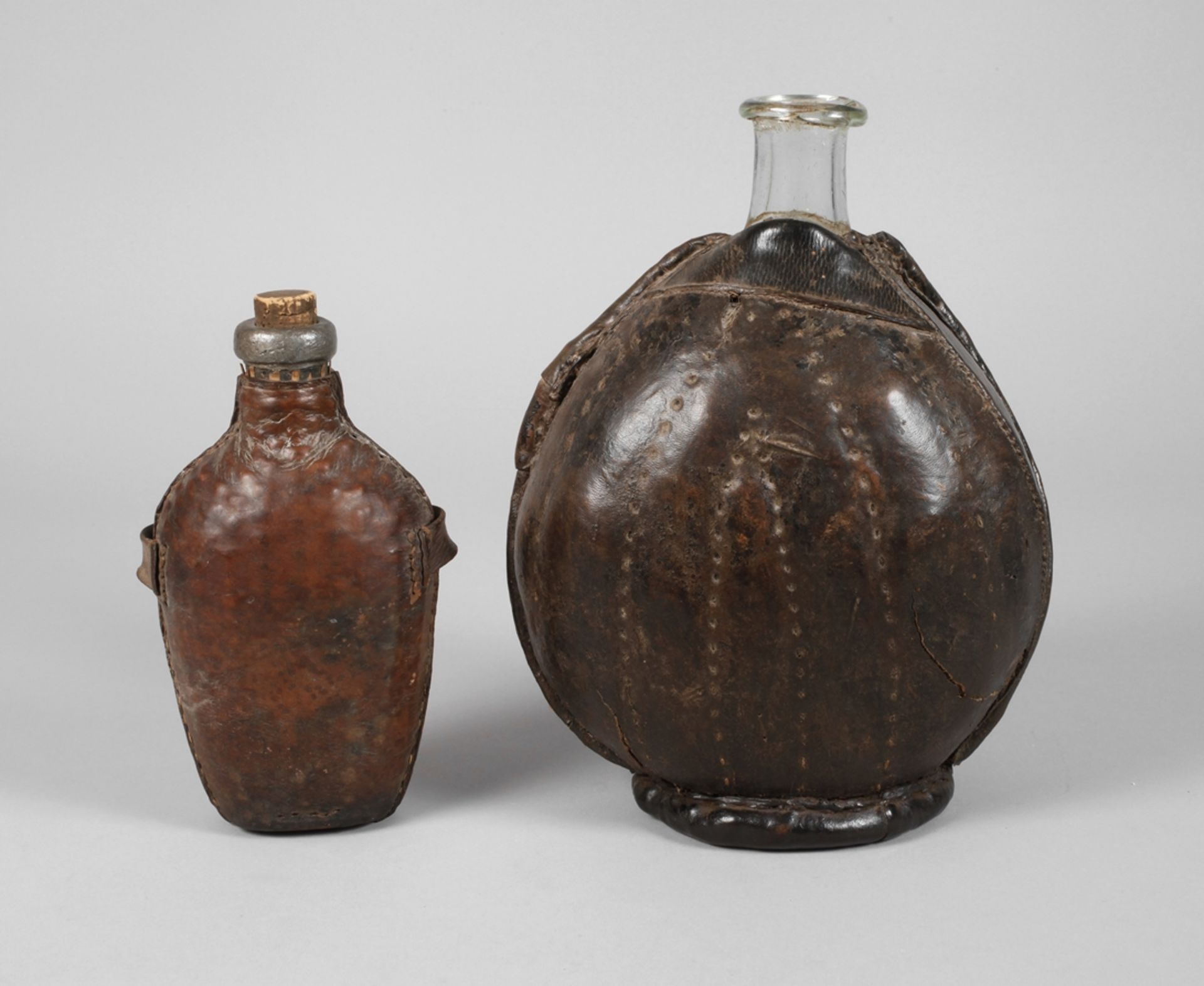 Two baroque bottles with leather cover
