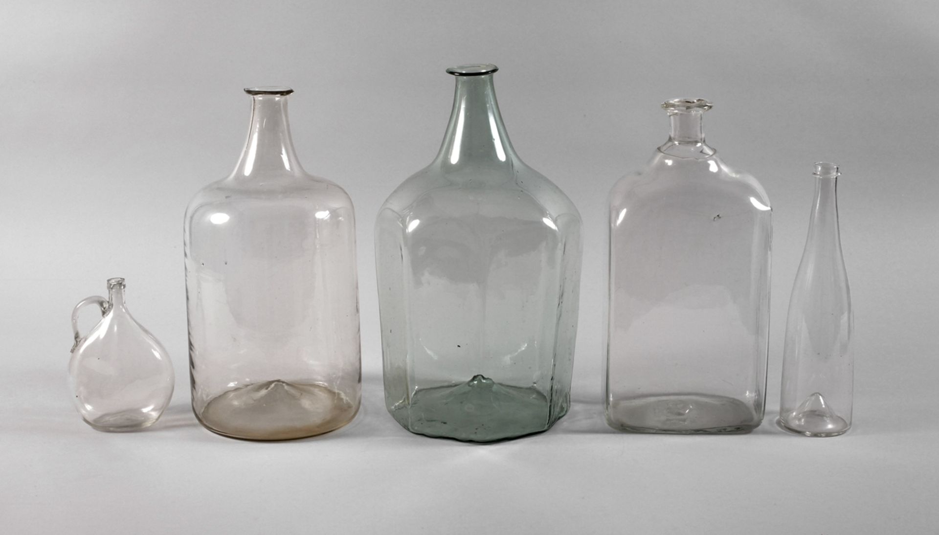 Five historical glass bottles