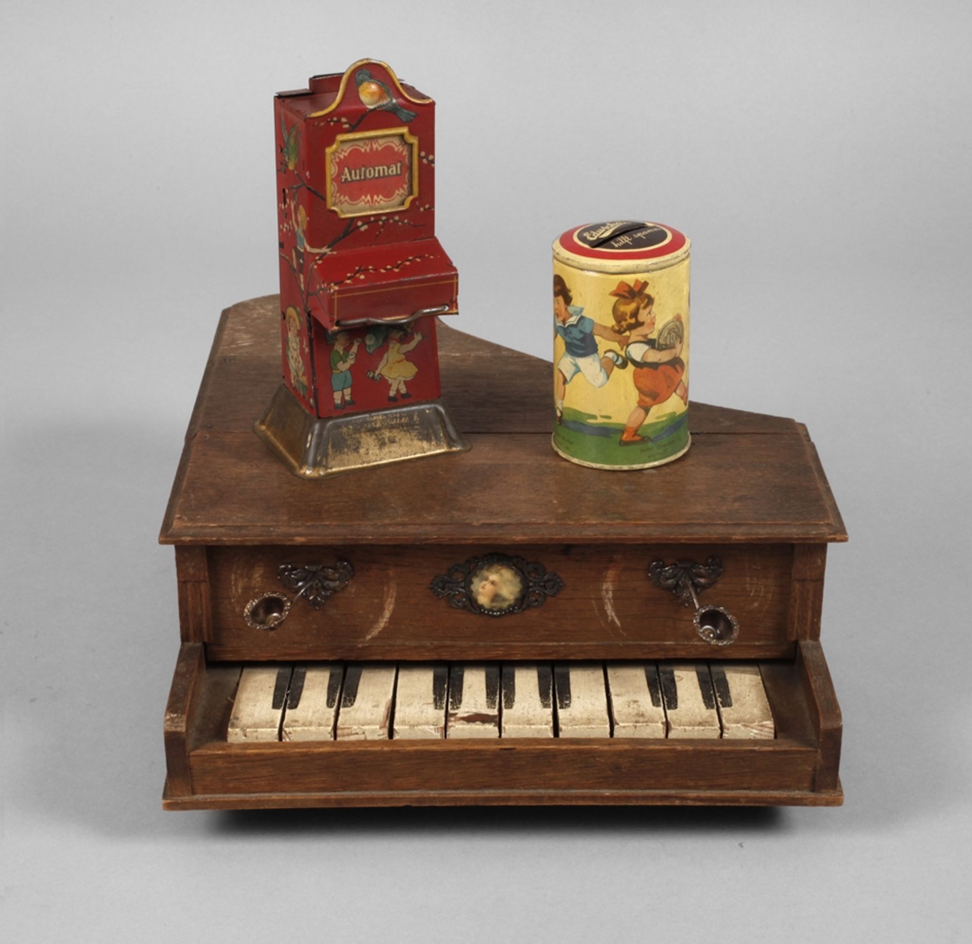 Two money boxes and children's grand piano