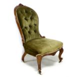 A Victorian button back nursing chair, with floral carved top-rail, upholstered in brown velvet,