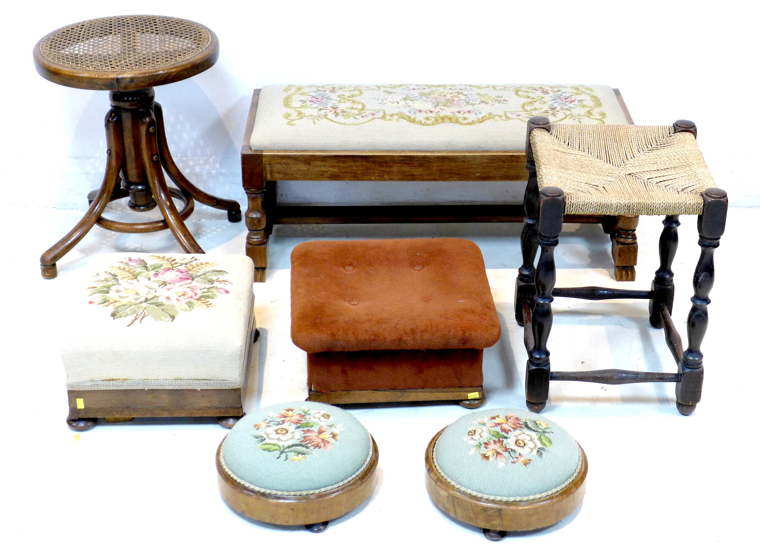 A group of seven stools, comprising a pair of Victorian circular footstools, with embroidered