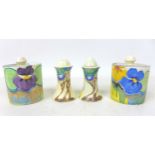 A group of Clarice Cliff pieces, comprising two 'Pansies' drum shaped preserve pots with lids,