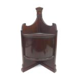 A small mahogany wall hanging corner cupboard, bow fronted, single door, 31 by 20 by 55cm high.