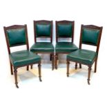A set of four late Victorian dining chairs, carved frames, green leatherette seats and backs, each