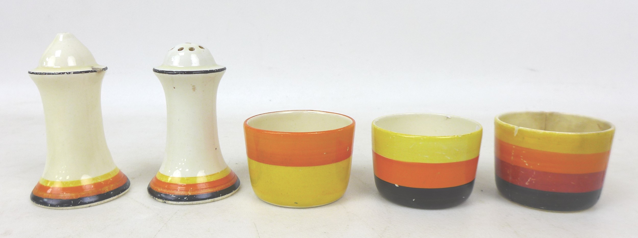A collection of Clarice Cliff banded wares, including a Muffineer salt and pepper pot, 8cm high, and