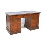 An Edwardian oak twin pedestal desk, with nine drawers, turned handles, a/f one drawer missing