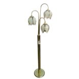 A modern standard lamp, with three flowerhead shaped lights, brass column, on a circular base.