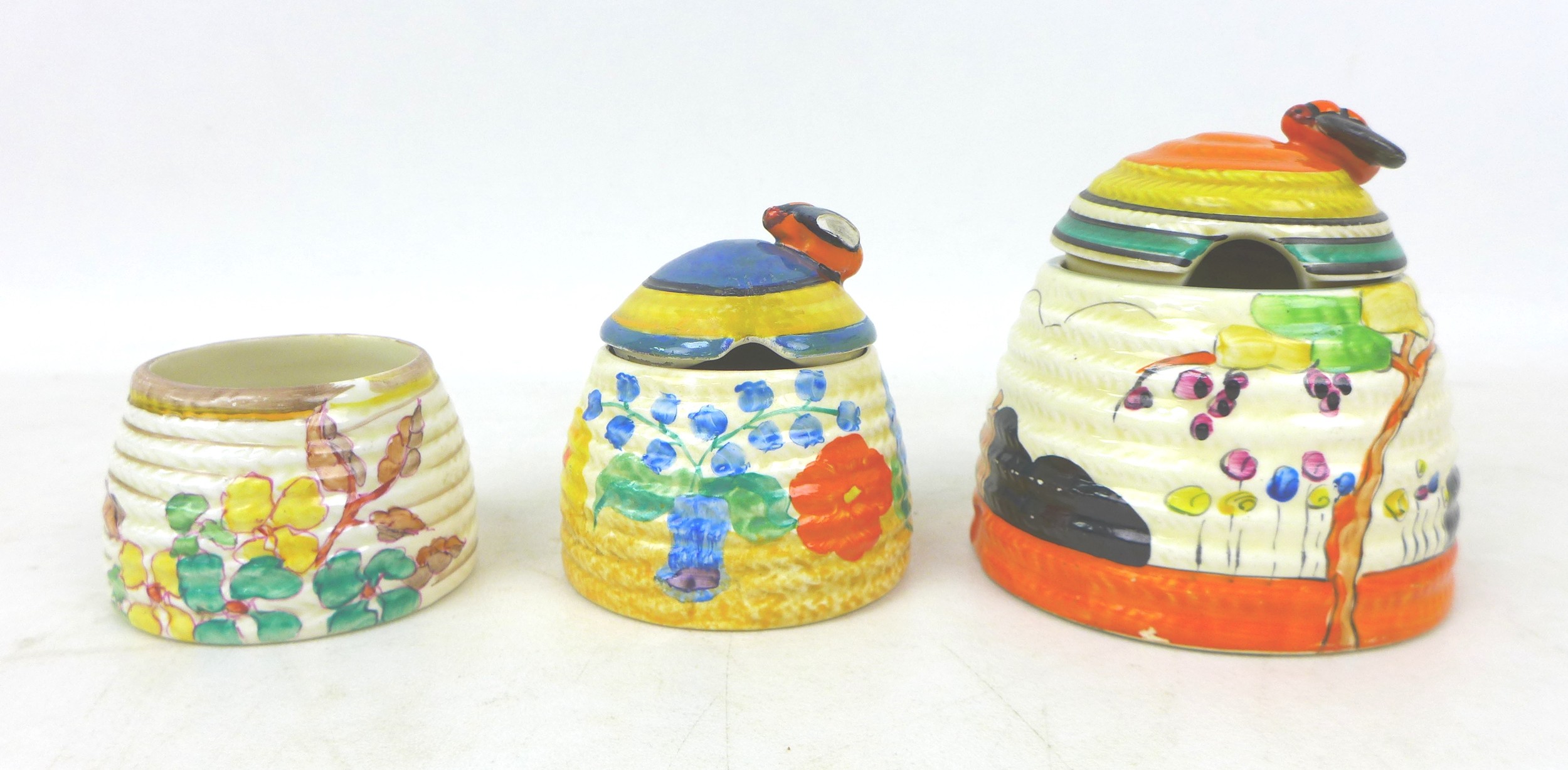 A group of three Clarice Cliff Beehive honey pots, Including 'Tulips','Canterbury Bells', and '