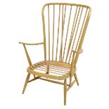 A blonde beech Ercol tall back easy armchair.