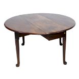 An 19th century mahogany drop leaf dining table, with oval surface, twin gate leg action, raised