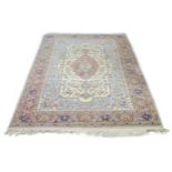 A machine made rug, cream and pale blue ground, floral decoration, with signature panel, 308 by