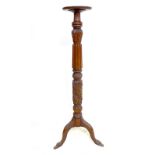 An Edwardian mahogany jardiniere stand, with dished circular and gadrooned surface, raised on a
