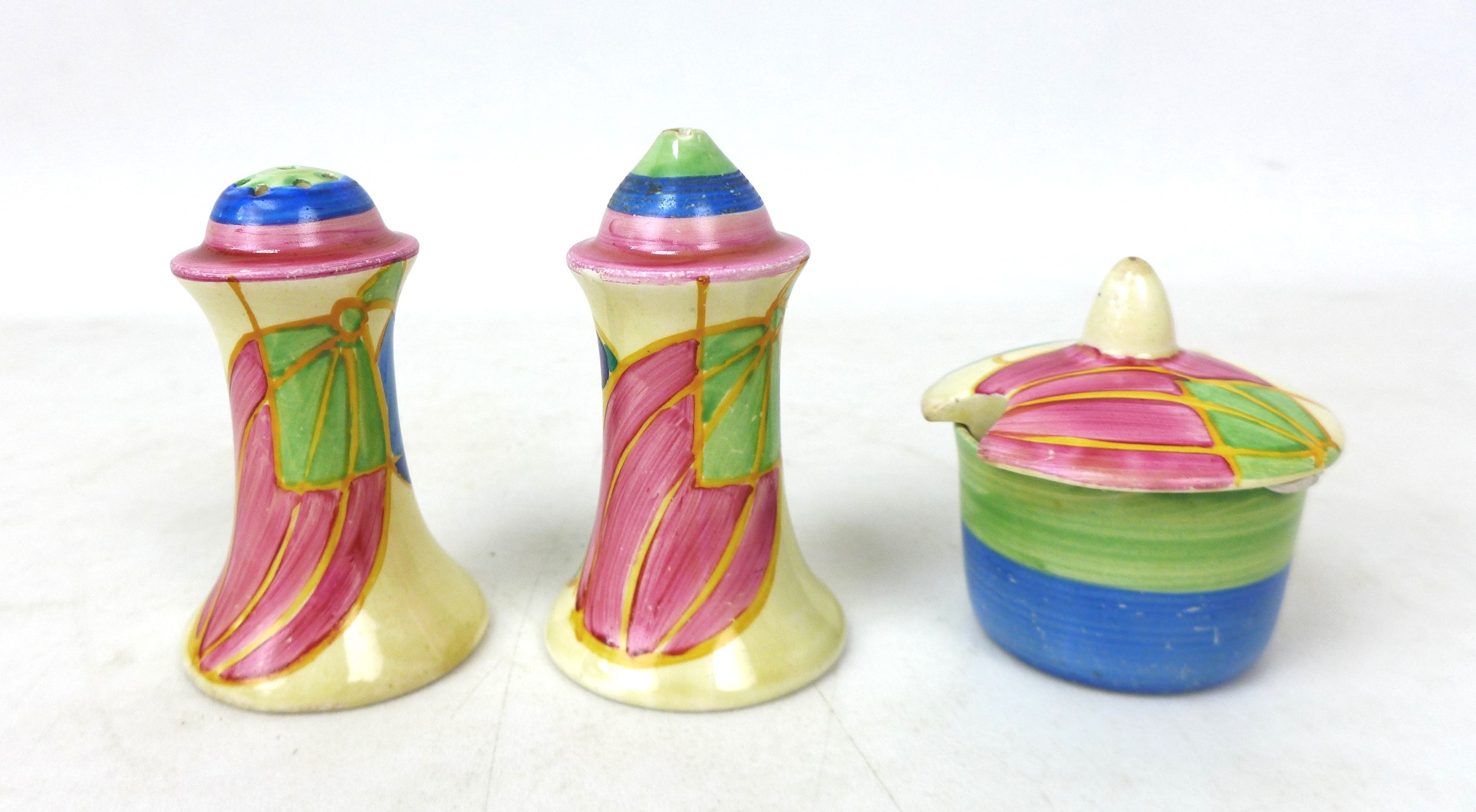 A Clarice Cliff 'Pastel Melon' Muffineer cruet set, each marked to the base, tallest 8cm high. (3)