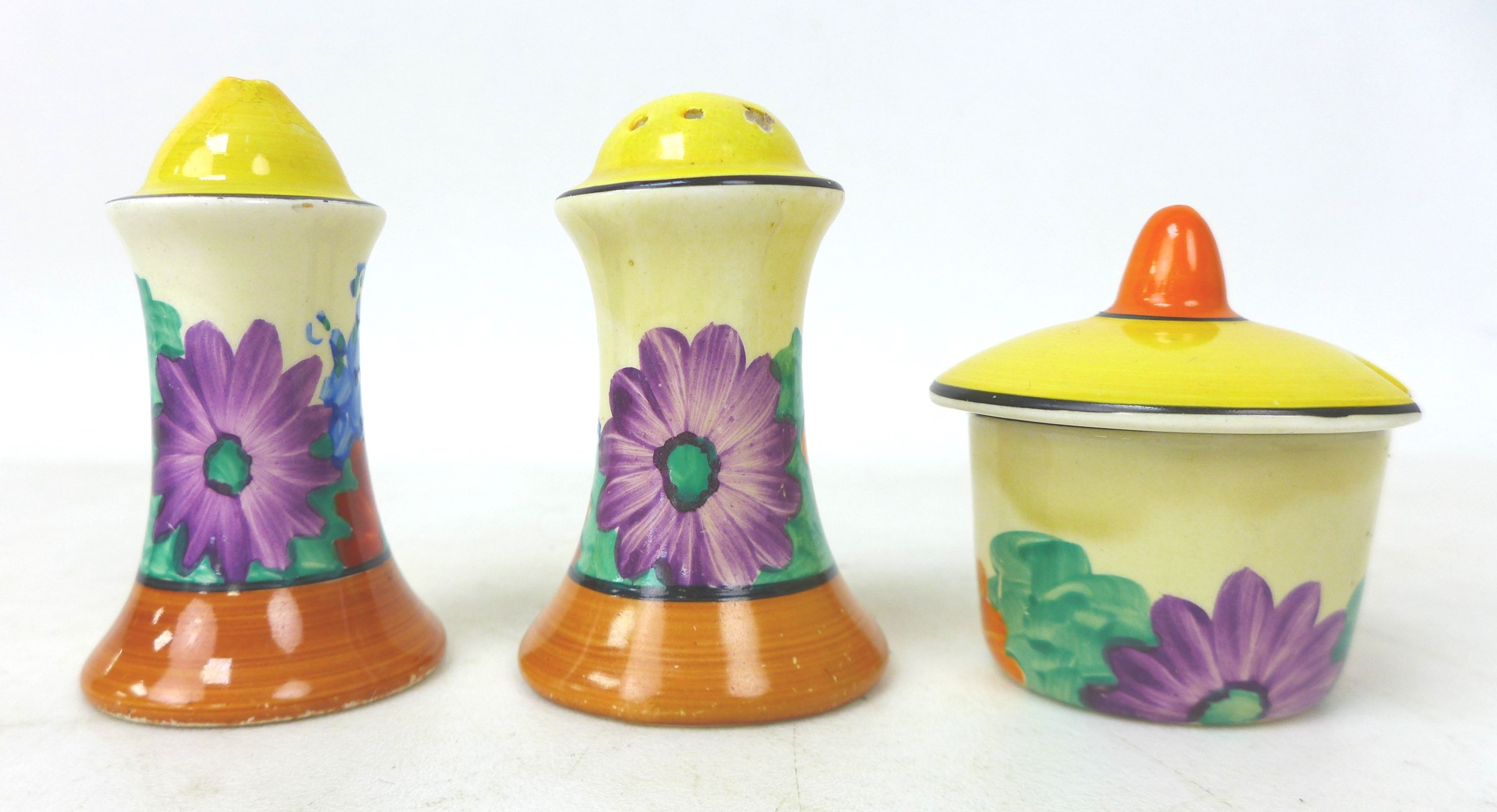 A Clarice Cliff 'Gay Day' Muffineer cruet set, Bizarre mark to the base, tallest 8cm high. (3)