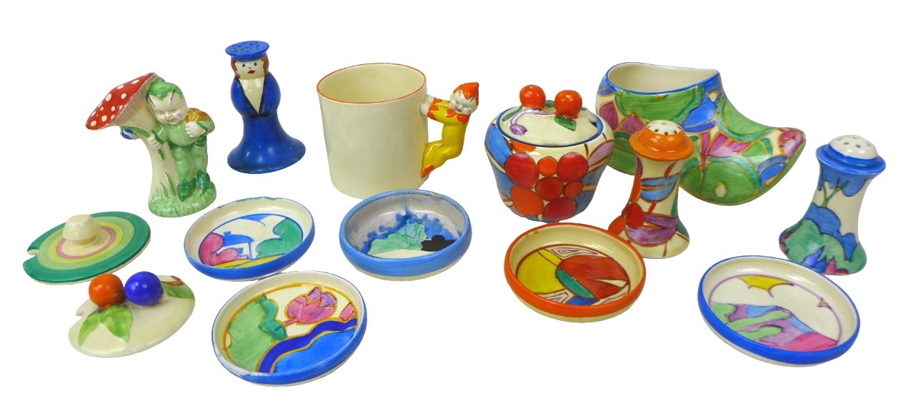 A mixed group of Clarice Cliff, comprising a 'United Service' pepper pot, 9cm high; a mug with