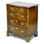 A late 20th century chest of four drawers, in George III style, serpentine front, crossbanded and