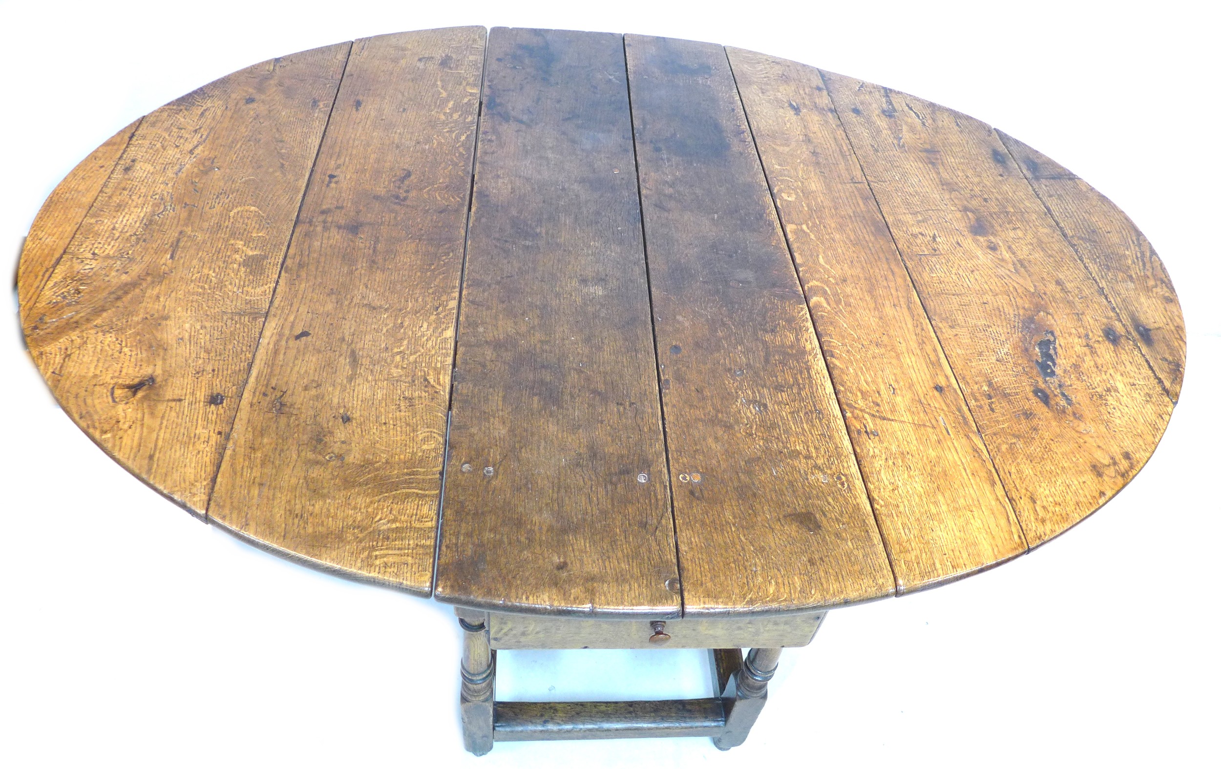 A 17th or 18th century oak drop leaf dining table, with oval surface, twin gate leg action, raised - Image 3 of 5