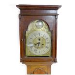 A George III oak long case clock, brass dial with silvered chapter rings, engraved and black painted