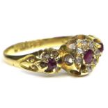 An 18ct gold, ruby and diamond ring, with central rose cut ruby surrounded by seven old cut