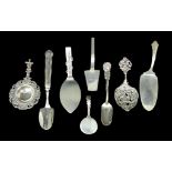 Eight pieces of British and international silver and white metal, comprising two tea straining