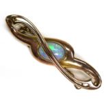 A 9ct gold and opal bar brooch, the stone an oval cabochon of approximately 8.5 by 5mm, the brooch