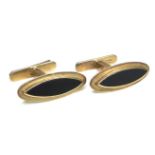 A pair of vintage 9ct gold cufflinks, each of slender navette shape inset with a black stone, '