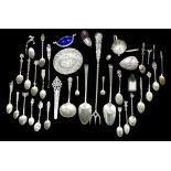A collection of assorted British and continental silver and white metal flatware, including a