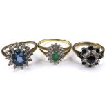 A group of three 9ct gold flowerhead rings, one set with a marquise shaped emerald, 6mm long,