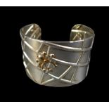 A Tiffany & Co. silver web cuff bangle, designed by Elsa Peretti, with spider and web design, 1.