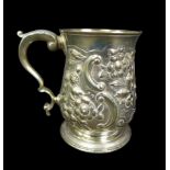 A George III silver tankard, with later repousse decoration, of baluster form with double C scroll