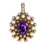 An unmarked yellow metal pendant, in Renaissance style, set centrally with an oval cut amethyst,