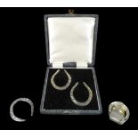 A collection of 20th century horseshoe shaped silver items, comprising a cased set of two silver