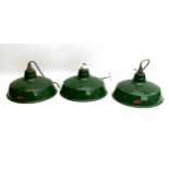 A set of three industrial green enamel pendant lights, with white interiors, a/f electrical fittings