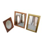 Three early 20th century and later mirrors, including an oak framed mirror with oval glass, 35 by