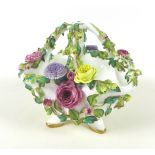 A Continental 'Meissen' style footed basket bowl, with applied floral and foliate detail,